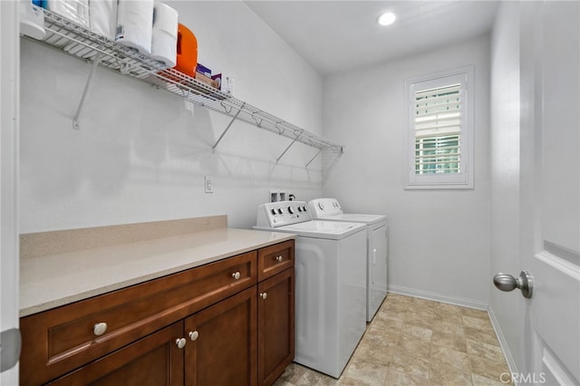 clothes washing area featuring laundry area, washing machine and dryer, and baseboards