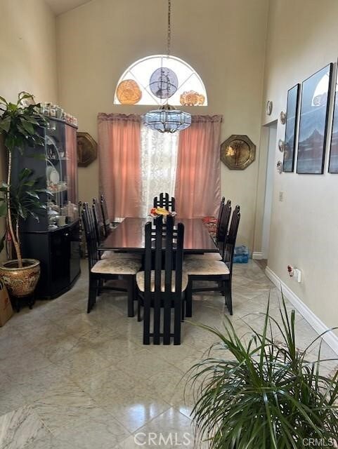 30103 Desert Rose Dr, Castaic, CA 91384 - dining space featuring a chandelier and a high ceiling