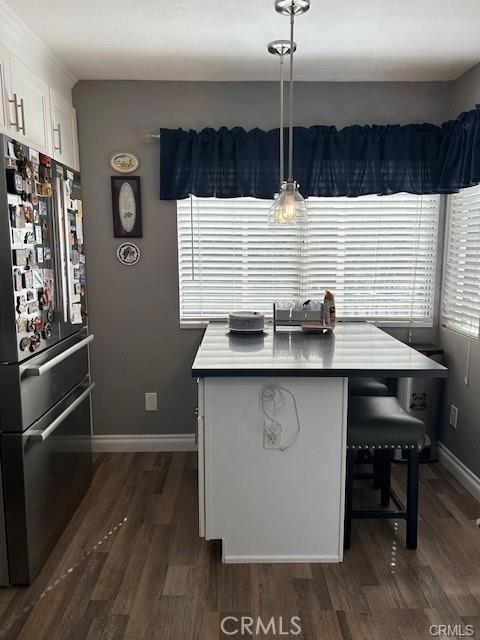 30103 Desert Rose Dr, Castaic, CA 91384 - dining room featuring dark wood-style flooring and baseboards