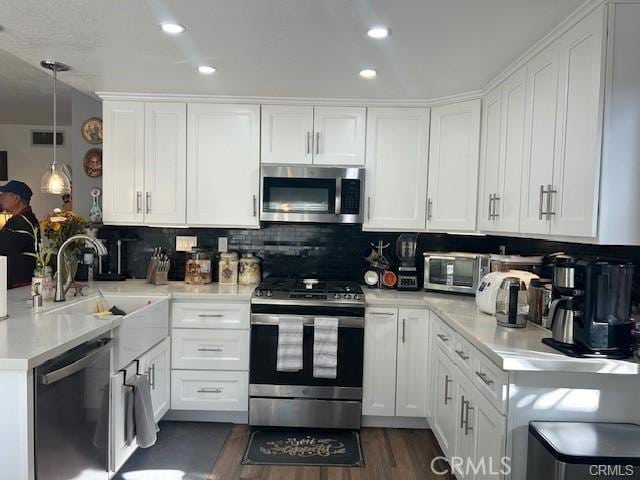 kitchen featuring stainless steel appliances, visible vents, light countertops, and white cabinetry