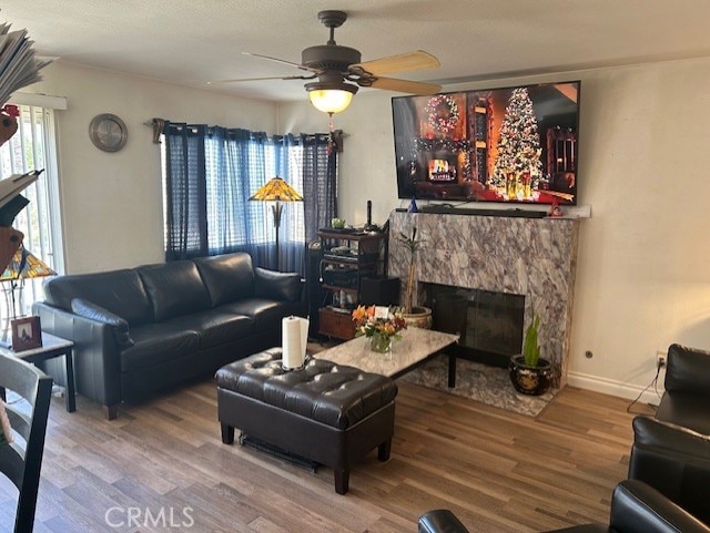 30103 Desert Rose Dr, Castaic, CA 91384 - living area with wood finished floors, ceiling fan, and a premium fireplace