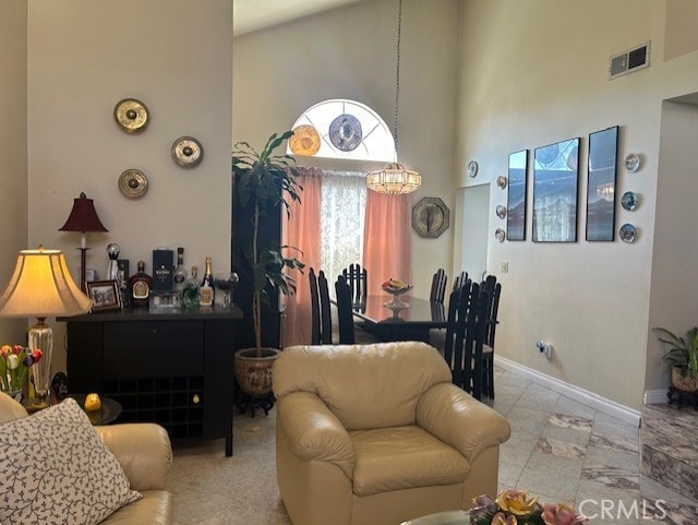 30103 Desert Rose Dr, Castaic, CA 91384 - dining space featuring a high ceiling, a chandelier, and marble look tiles