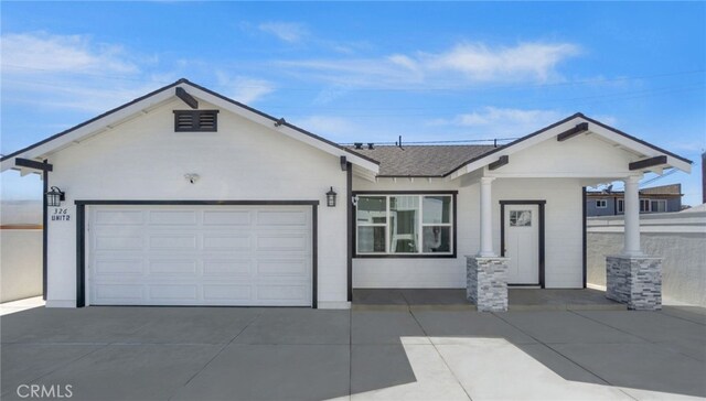 ranch-style house with a garage, concrete driveway, stucco siding, and a shingled roof