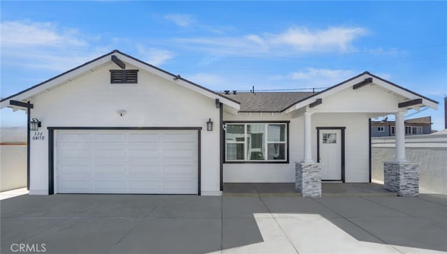 ranch-style home featuring a garage, driveway, and a shingled roof