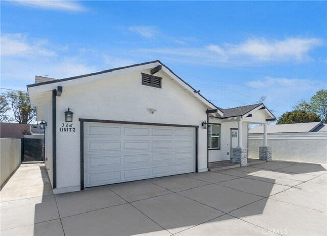 ranch-style home with stucco siding, driveway, and an attached garage