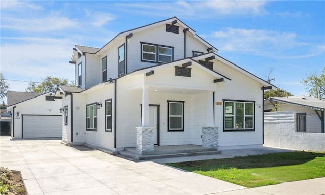 view of front of house with a garage, covered porch, and driveway