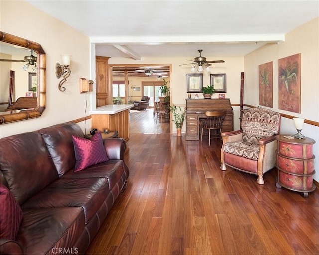 living room featuring beamed ceiling, ceiling fan, and dark wood-style flooring