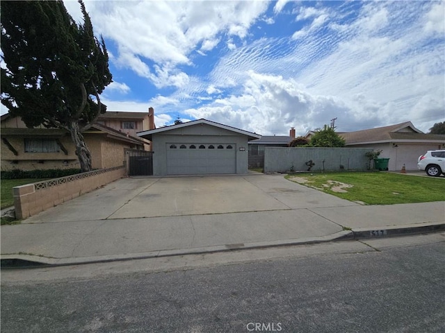 view of front of house featuring a garage, driveway, a front lawn, and fence