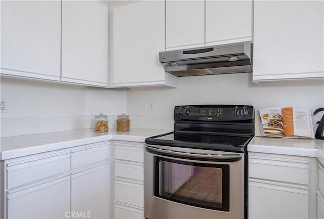 kitchen with white cabinetry, under cabinet range hood, and stainless steel range with electric cooktop