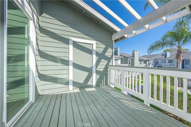 deck featuring a residential view and a pergola