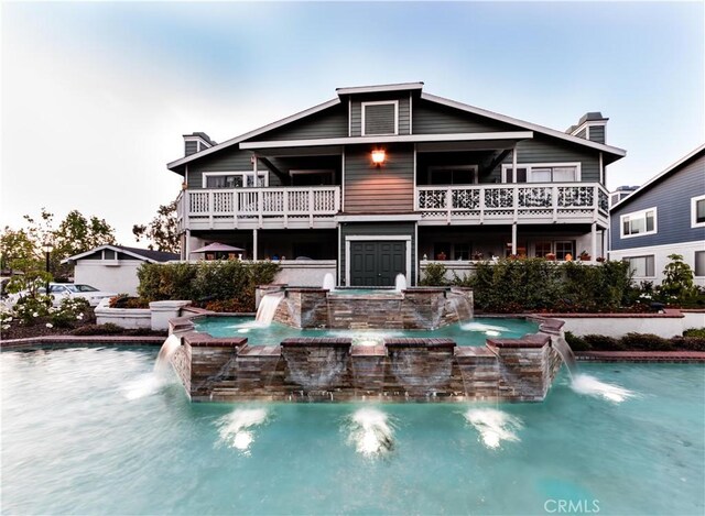 back of house featuring a hot tub