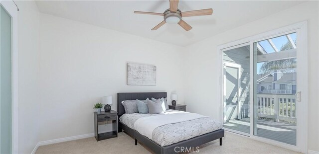 bedroom with baseboards, multiple windows, light colored carpet, and access to outside