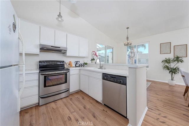 kitchen with under cabinet range hood, a sink, stainless steel appliances, a peninsula, and light countertops