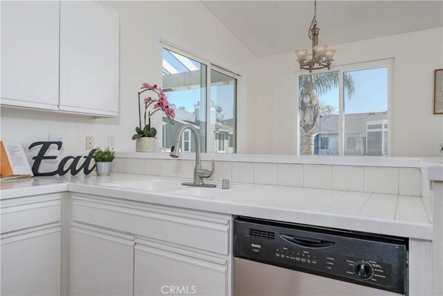 kitchen featuring a sink, stainless steel dishwasher, a healthy amount of sunlight, and white cabinets