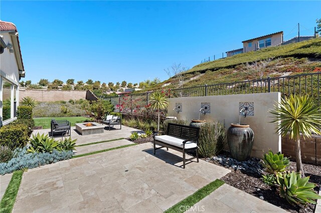 view of patio with a fenced backyard and an outdoor fire pit