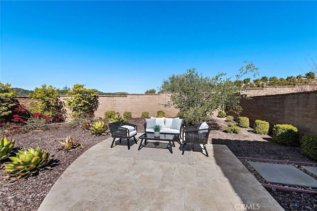 view of patio featuring an outdoor living space and a fenced backyard