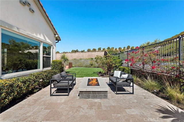 view of patio featuring an outdoor living space with a fire pit and a fenced backyard