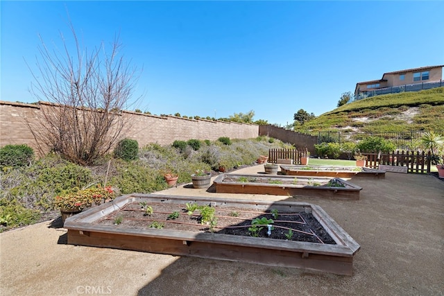 view of yard with a vegetable garden and fence