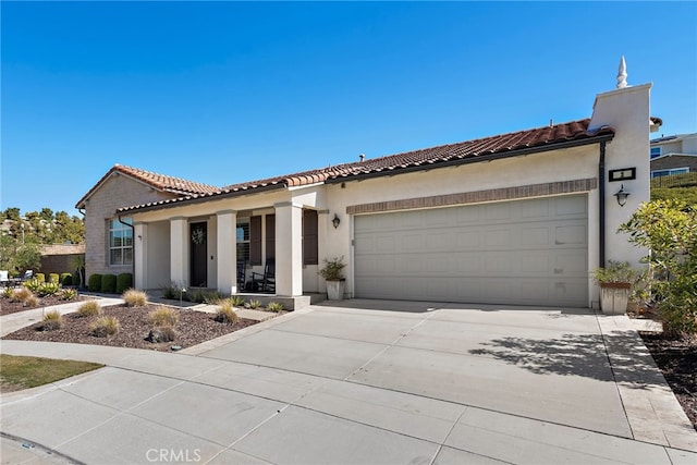 mediterranean / spanish-style home with stucco siding, an attached garage, a tile roof, and driveway