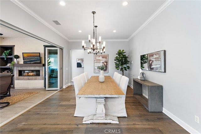 dining room with visible vents, baseboards, dark wood-type flooring, and crown molding