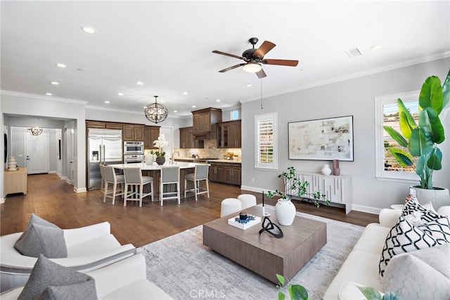 living room with a wealth of natural light and ornamental molding