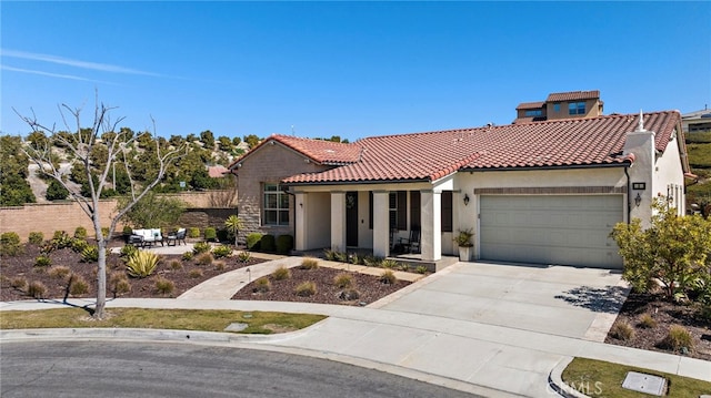 mediterranean / spanish home featuring stucco siding, fence, concrete driveway, an attached garage, and a tiled roof