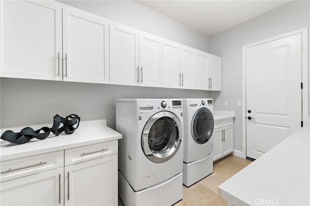 laundry room featuring cabinet space and washing machine and clothes dryer