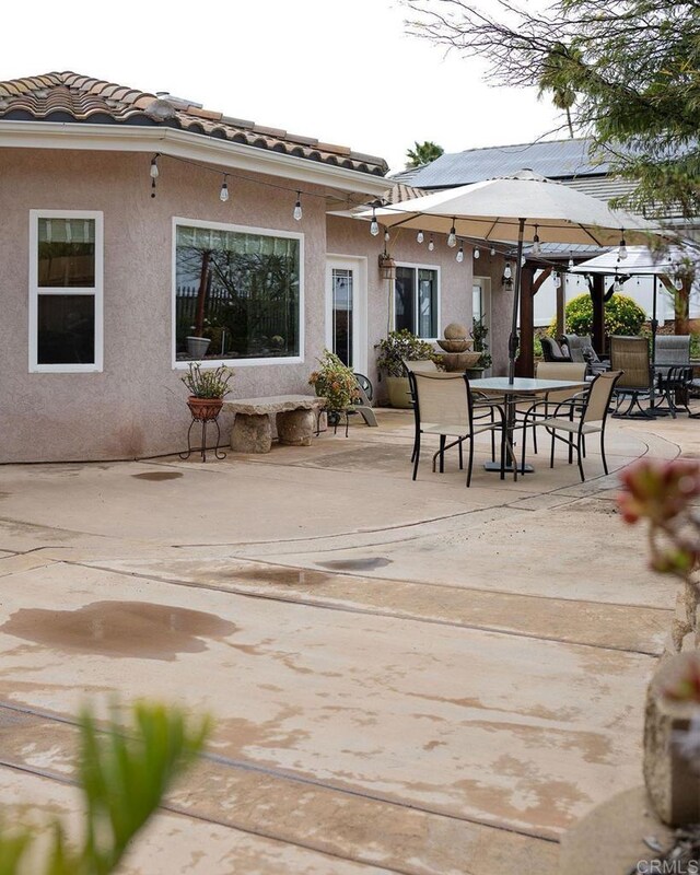 view of patio featuring outdoor dining area