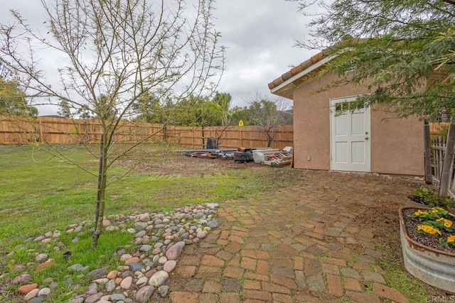 view of yard featuring a fenced backyard and a patio area