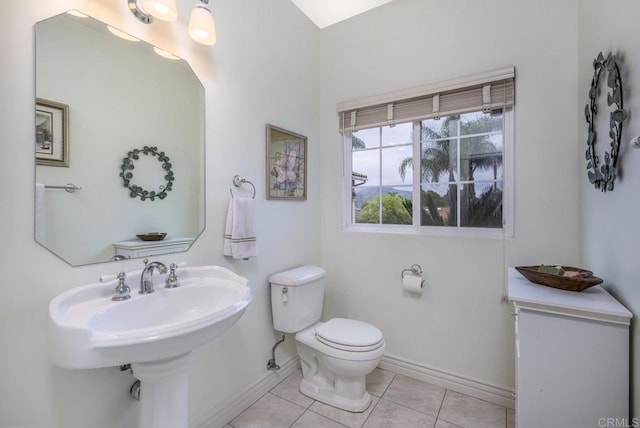 bathroom with tile patterned floors, toilet, and baseboards