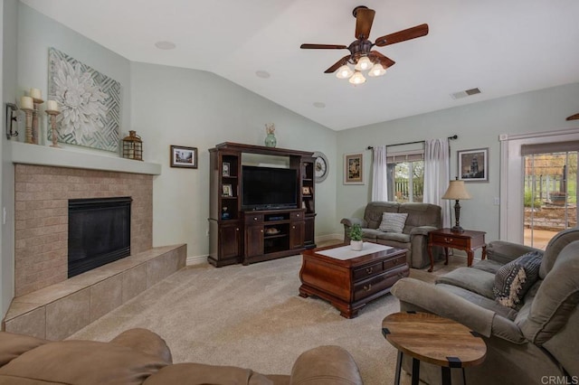 living room featuring visible vents, ceiling fan, lofted ceiling, carpet floors, and a fireplace