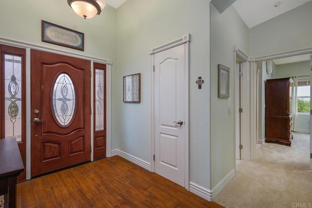 foyer entrance with baseboards and wood finished floors