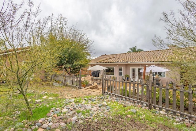 view of yard featuring french doors, a patio, and fence