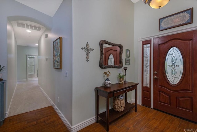 entryway featuring dark wood-style floors, visible vents, and baseboards