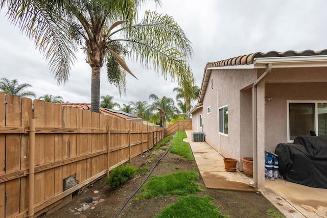 view of yard featuring central AC unit and a fenced backyard