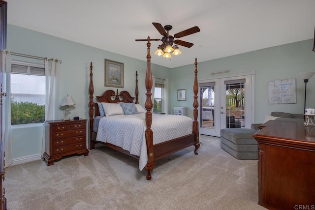 carpeted bedroom featuring french doors, multiple windows, a ceiling fan, and access to outside