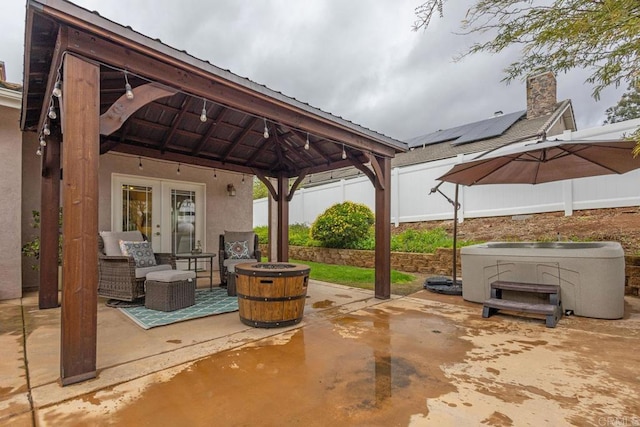 view of patio / terrace featuring a gazebo, french doors, and fence