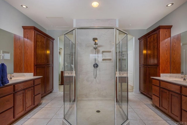 bathroom featuring a sink, two vanities, a stall shower, and tile patterned flooring