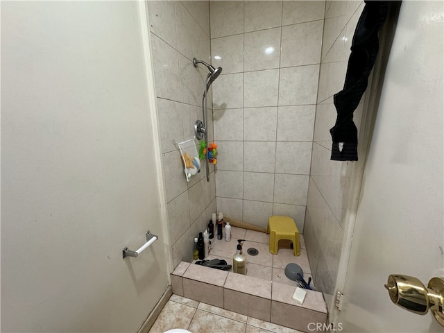 full bath featuring tile patterned floors and tiled shower