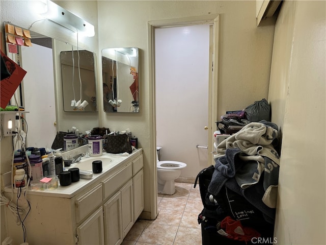 bathroom featuring vanity, tile patterned floors, and toilet