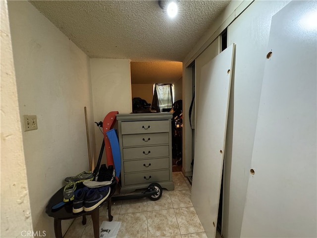 18620 Hatteras St Unit 166, Tarzana, CA 91356 - corridor with a textured ceiling and light tile patterned flooring