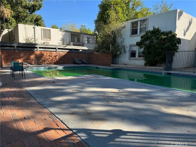 view of pool with a fenced in pool, a patio, and fence