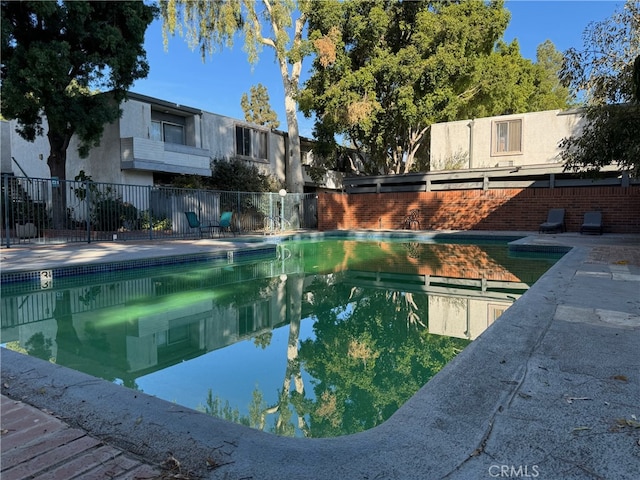 view of pool featuring a patio area, a fenced in pool, and fence