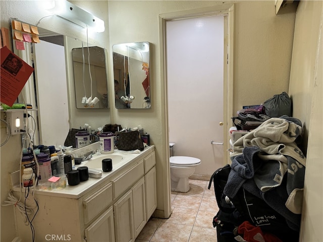 bathroom with tile patterned flooring, toilet, and vanity