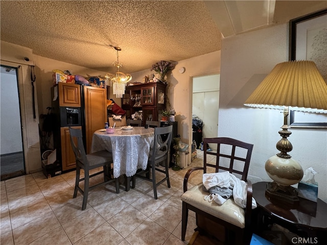 18620 Hatteras St Unit 166, Tarzana, CA 91356 - dining area featuring a textured ceiling, a notable chandelier, and light tile patterned floors