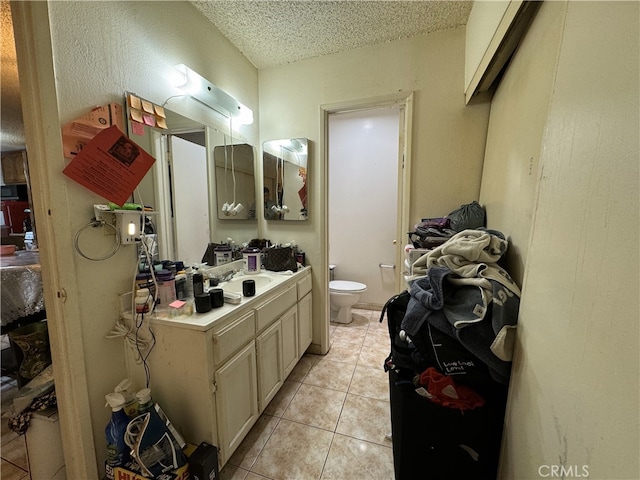 18620 Hatteras St Unit 166, Tarzana, CA 91356 - bathroom with vanity, toilet, tile patterned flooring, and a textured ceiling