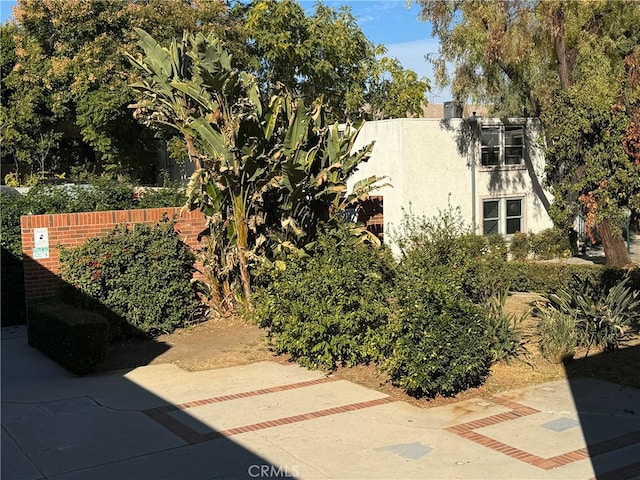 exterior space featuring fence and stucco siding