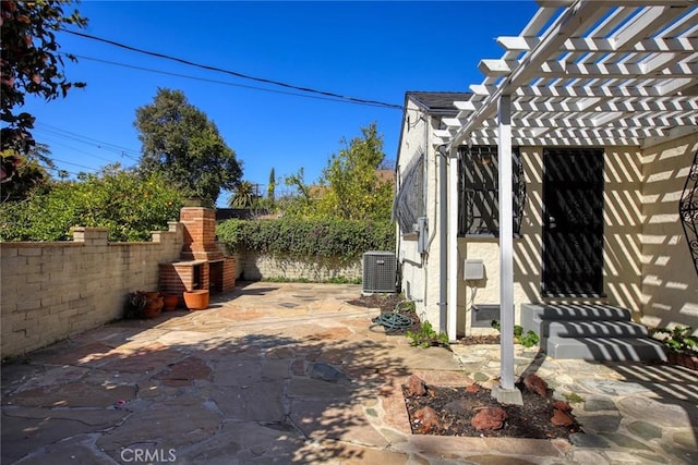 view of patio / terrace with central air condition unit, a pergola, and fence