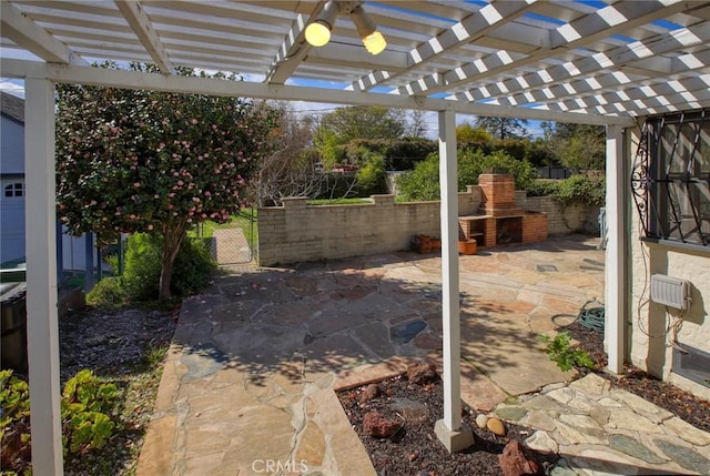 view of patio / terrace with a fireplace and fence