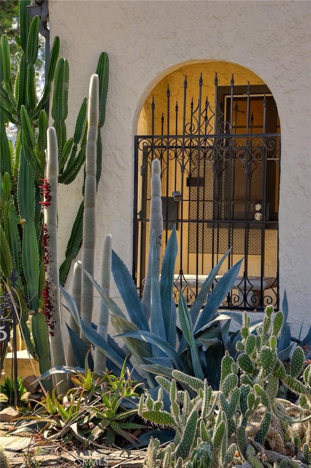 details featuring arched walkways and stucco siding